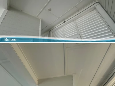 Before and after softwash of Galveston beach house Hardie board patio wall, restored and spotless