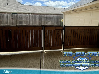 Wood fence panel after soft washing and sealer application at a Pearland home
