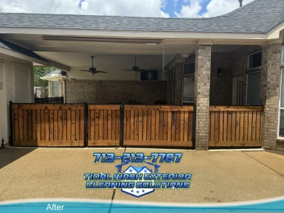 Wood fence near brick exterior after soft washing and sealer application in Pearland